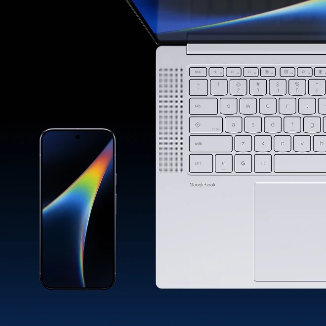 An open Lenovo Googlebook sitting next to a Google Pixel on a dark table.