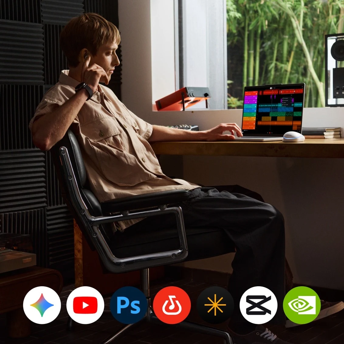 A person uses a Lenovo Googlebook while sitting at their desk, with app icons displayed along the bottom.