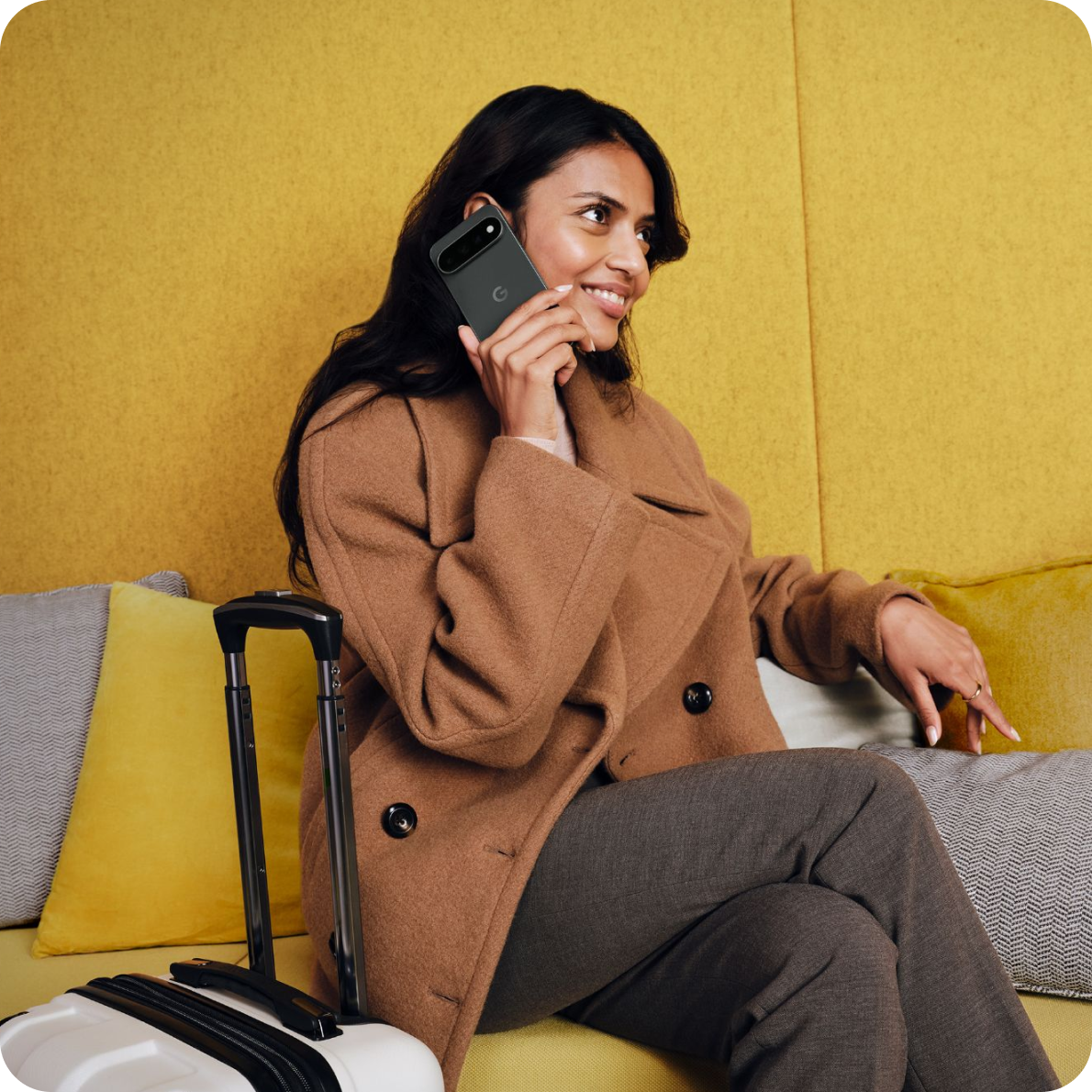 A woman traveler talking on her Google Pixel 11 phone.