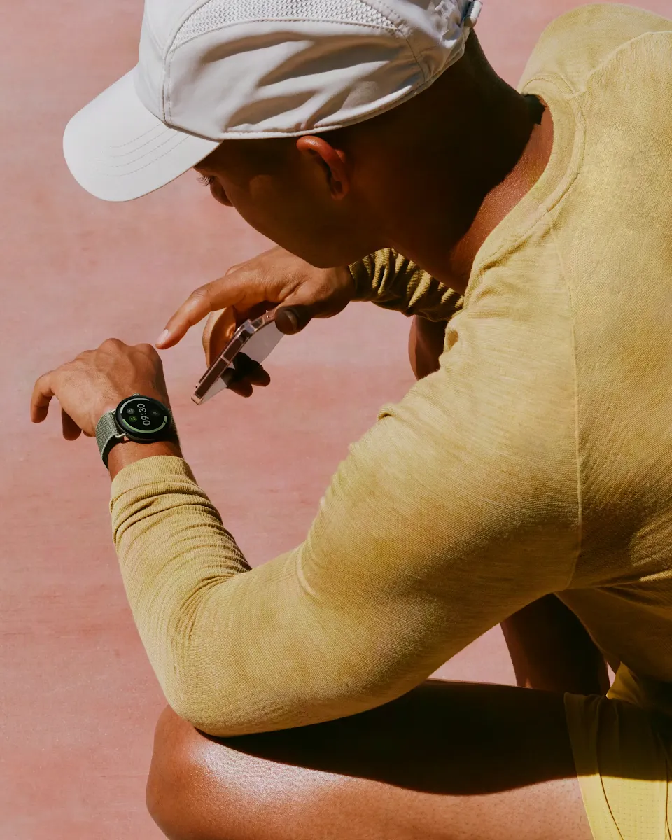 A person resting hands-on-knees while on a run