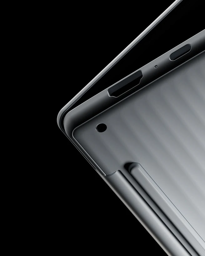 A close-up view of the metallic hinge and corner edge of a slightly open Lenovo Googlebook laptop.
