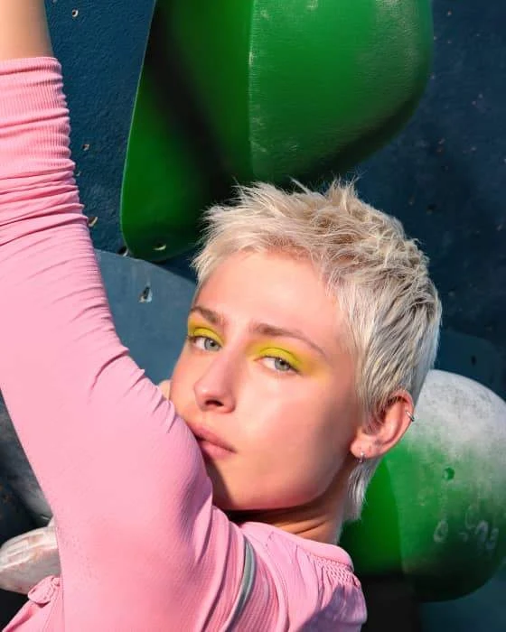 Perfectly lit portrait of a person standing in front of a colorful wall.