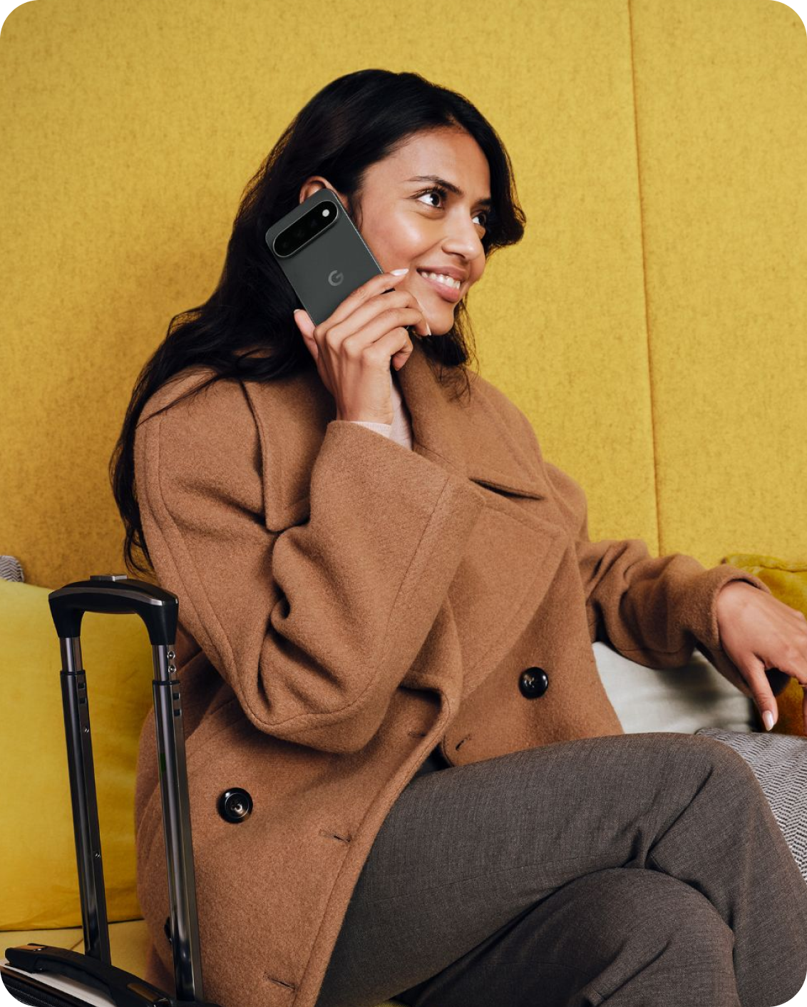 A woman traveler talking on her Google Pixel 11 phone.