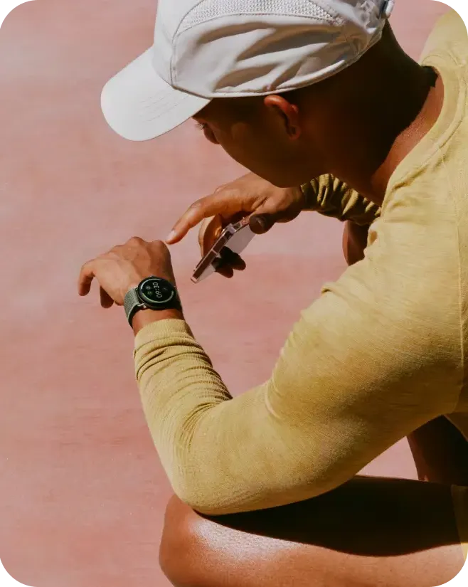 A person resting hands-on-knees while on a run