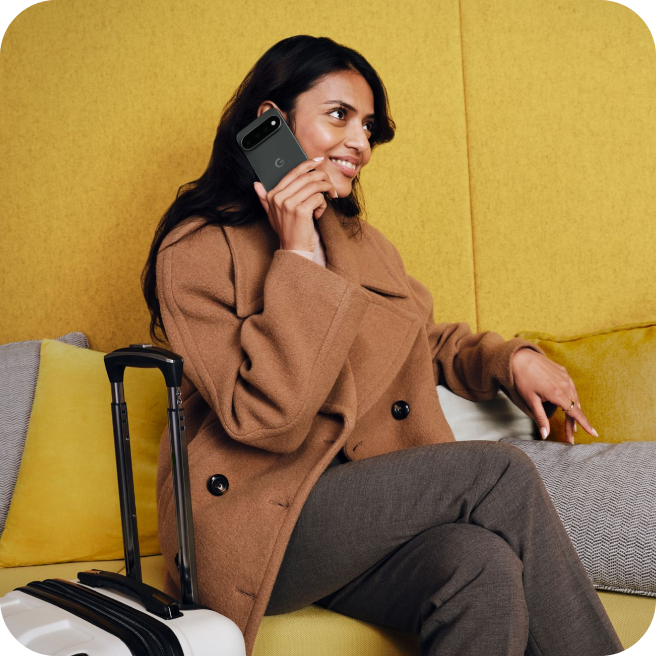 A woman traveler talking on her Google Pixel 11 phone.