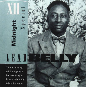 Lead Belly in suit and bow tie on vintage album cover with floral wallpaper background. — Singer Picture