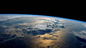 Planet Earth seen from orbit with sunlit clouds and dark oceans against the blackness of space. — Earth Wallpaper