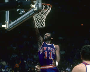 Basketball player in New York Knicks jersey dunks the ball in a packed arena. — NBA Wallpaper
