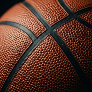 Nærbilde av en basketballs strukturerte overflate og svarte sømmer. bakgrunner