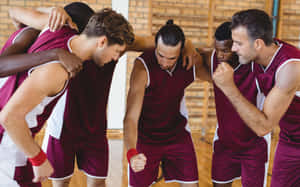 Basketball team huddles together in a circle on a wooden court. — NBA Wallpaper