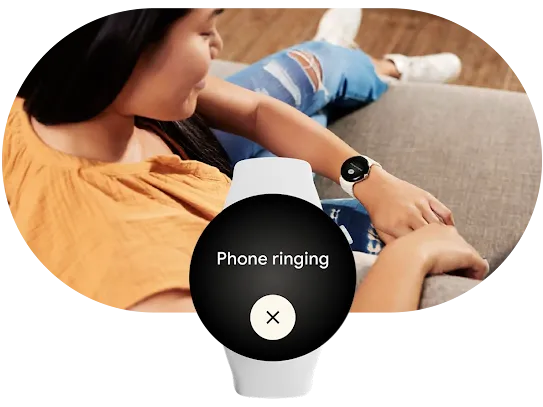 In the foreground, a smartwatch showing Find my phone and the message “Phone ringing.” Behind it, a person sits on a couch looking at their smartwatch.
