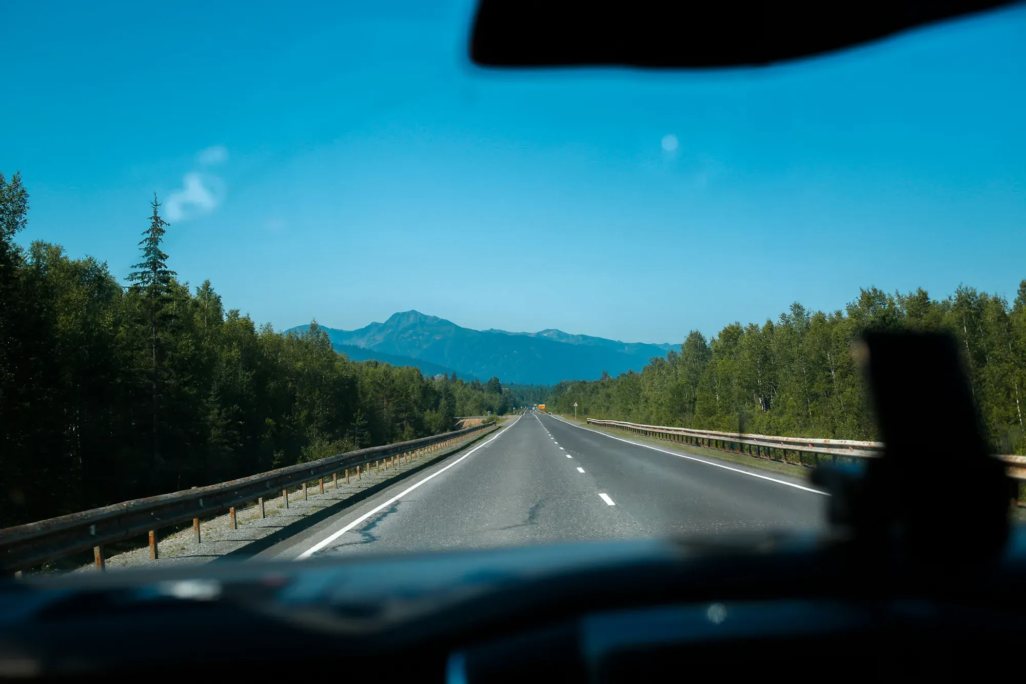 Driver using waze navigation app displaying open highway driving directions and fastest route